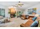 Living room with a fireplace, hardwood floors, and large windows at 14631 Village Glen Cir, Tampa, FL 33618