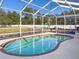 Refreshing kidney-shaped pool in a screened patio at 15265 Hiburn St, Brooksville, FL 34604