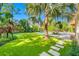 Spacious backyard with artificial turf, tropical landscaping, a pool, and covered lanai at 1925 Beach Se Dr, St Petersburg, FL 33705