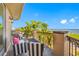 Comfortable balcony seating offers a great view of the ocean and blue sky with palm trees in the distance at 1925 Beach Se Dr, St Petersburg, FL 33705