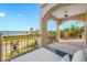 Relaxing covered balcony with wrought iron railing offers serene water views and comfortable seating at 1925 Beach Se Dr, St Petersburg, FL 33705
