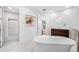 Bright bathroom featuring a soaking tub, marble floors, and modern fixtures, creating a spa-like experience at 1925 Beach Se Dr, St Petersburg, FL 33705