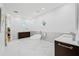 Elegant bathroom with a freestanding tub, marble floors, custom vanities, and decorative windows for natural light at 1925 Beach Se Dr, St Petersburg, FL 33705
