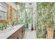 Bathroom with double vanity, tropical wallpaper, and shower/tub combo at 1925 Beach Se Dr, St Petersburg, FL 33705