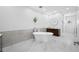 Bright bathroom featuring a soaking tub, marble floors, and modern fixtures, creating a spa-like experience at 1925 Beach Se Dr, St Petersburg, FL 33705