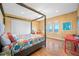 Inviting bedroom featuring a four-poster bed, hardwood floors, and picturesque windows with water views at 1925 Beach Se Dr, St Petersburg, FL 33705