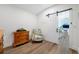 Bedroom with a wooden dresser, floral armchair, and a sliding barn door at 1925 Beach Se Dr, St Petersburg, FL 33705