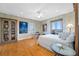 Bright bedroom with light wood floors, built-in bookcase, work area, and a sliding glass door to the balcony at 1925 Beach Se Dr, St Petersburg, FL 33705