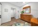 Bright bedroom featuring a wooden dresser with mirror, complementing the hardwood floors and neutral walls at 1925 Beach Se Dr, St Petersburg, FL 33705