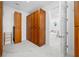 Spacious closet featuring custom wood cabinetry, marble floors, and a doorway leading to a luxurious bathroom at 1925 Beach Se Dr, St Petersburg, FL 33705