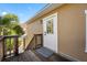 Exterior entryway featuring a raised wooden deck, stairs, and a white door with a decorative window at 1925 Beach Se Dr, St Petersburg, FL 33705