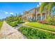Beautiful home exterior with lush landscaping, palm trees, and architectural details, creating a welcoming curb appeal at 1925 Beach Se Dr, St Petersburg, FL 33705