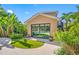 Exterior view of a cabana with glass sliding doors, lush greenery, and a nearby pool at 1925 Beach Se Dr, St Petersburg, FL 33705
