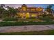 Elegant home exterior with manicured front yard, lush landscaping, and a stone walkway at 1925 Beach Se Dr, St Petersburg, FL 33705