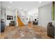 Open foyer with tile floors, elegant staircase, and views of the dining and kitchen areas at 1925 Beach Se Dr, St Petersburg, FL 33705