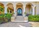 Elegant home entrance featuring classic columns, arched doorways, and manicured landscaping at 1925 Beach Se Dr, St Petersburg, FL 33705