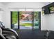 Home gym with exercise equipment and sliding glass doors providing a view of the pool and backyard at 1925 Beach Se Dr, St Petersburg, FL 33705