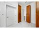 Hallway with white and wood doors, marble floors, and custom cabinetry for ample storage space at 1925 Beach Se Dr, St Petersburg, FL 33705