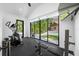 Bright home gym with dark floors, large sliding glass doors, and exercise equipment at 1925 Beach Se Dr, St Petersburg, FL 33705
