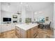 Bright kitchen boasts a central island with seating, modern appliances, and opens to a dining area with waterfront views at 1925 Beach Se Dr, St Petersburg, FL 33705