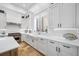 Beautiful kitchen with white cabinets, stainless steel appliances, and a farmhouse sink at 1925 Beach Se Dr, St Petersburg, FL 33705