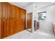 Well-equipped laundry room with custom cabinetry, modern washer and dryer, and elegant marble flooring at 1925 Beach Se Dr, St Petersburg, FL 33705