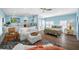 Inviting living room and bedroom combination featuring a comfortable sofa, floral bedding, and stylish decor at 1925 Beach Se Dr, St Petersburg, FL 33705