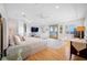 A light-filled main bedroom features a tray ceiling, hardwood floors, and access to a balcony with ocean views at 1925 Beach Se Dr, St Petersburg, FL 33705