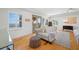 Bright main bedroom boasts hardwood floors, plantation shutters, a cozy sofa, and access to a private balcony at 1925 Beach Se Dr, St Petersburg, FL 33705