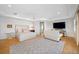 Spacious main bedroom with hardwood floors, tray ceiling, and a cozy sitting area with a large TV at 1925 Beach Se Dr, St Petersburg, FL 33705