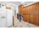 Mud room with tile floors, storage cabinets, refrigerator and a staircase at 1925 Beach Se Dr, St Petersburg, FL 33705