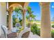 Charming patio with decorative columns, outdoor seating, and views of the surrounding greenery at 1925 Beach Se Dr, St Petersburg, FL 33705