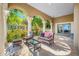 Inviting patio with stone flooring, comfortable seating, and elegant pillars overlooking lush greenery at 1925 Beach Se Dr, St Petersburg, FL 33705