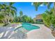 A backyard oasis with a beautiful pool, surrounding palm trees, and a sunny patio for ultimate relaxation at 1925 Beach Se Dr, St Petersburg, FL 33705
