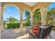 Charming covered porch with ornate columns and stylish seating area, perfect for relaxing and enjoying the outdoors at 1925 Beach Se Dr, St Petersburg, FL 33705