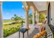 Covered porch with ornate columns, comfortable seating, and stunning water views at 1925 Beach Se Dr, St Petersburg, FL 33705