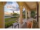 Inviting waterfront porch with decorative columns and colorful furniture for outdoor relaxation and enjoyment of stunning sunsets at 1925 Beach Se Dr, St Petersburg, FL 33705