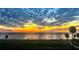 Sunset view of the open water featuring a golden sky and trees in the foreground at 1925 Beach Se Dr, St Petersburg, FL 33705