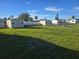 Large grassy backyard with shed and chain link fence at 202 7Th Nw St, Ruskin, FL 33570