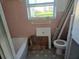 Bathroom with pink tile, bathtub, and toilet at 202 7Th Nw St, Ruskin, FL 33570