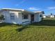 White single story home with a red door at 202 7Th Nw St, Ruskin, FL 33570