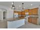 Kitchen features granite countertops and light wood cabinets at 2226 Nottingham Greens Dr, Sun City Center, FL 33573