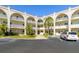 Front view of a two-story condo building with parking and landscaping at 2258 World Parkway W Blvd # 12, Clearwater, FL 33763