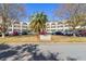 Full view of the condo building with landscaping and parking at 2258 World Parkway W Blvd # 12, Clearwater, FL 33763