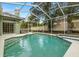 Relaxing screened-in pool with a spa and ample space for lounging at 3077 Regal Oaks Blvd, Palm Harbor, FL 34684