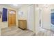 Inviting entryway featuring wood-look flooring, a wooden front door, and stylish storage cabinet near a convenient closet at 3407 King George Ln, Seffner, FL 33584