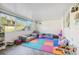 Sunroom with comfy seating, colorful play mat, and plenty of natural light at 3407 King George Ln, Seffner, FL 33584