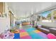 Bright sunroom featuring a colorful play area, comfortable seating, and large windows overlooking the backyard at 3407 King George Ln, Seffner, FL 33584