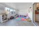 Sunroom with comfy seating, colorful play mat, and plenty of natural light at 3407 King George Ln, Seffner, FL 33584
