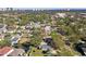 Aerial view of a house with a pool in a tree-lined residential neighborhood near the beach at 4003 W Euclid Ave, Tampa, FL 33629